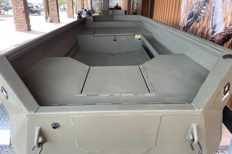 Slide: The Image of 2026 Reaper Boats 553 Timber Reaper, spacious interior, olive green finish, outdoor setting. - 5