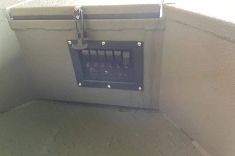 Slide: The Image of Control panel inside 2026 Reaper Boats 553 Timber Reaper, featuring multiple switches and outlets. - 8