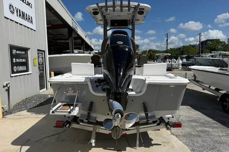 Slide: The Image of 2026 Sea Pro 230 Bay boat with outboard motor at a dealership. - 11