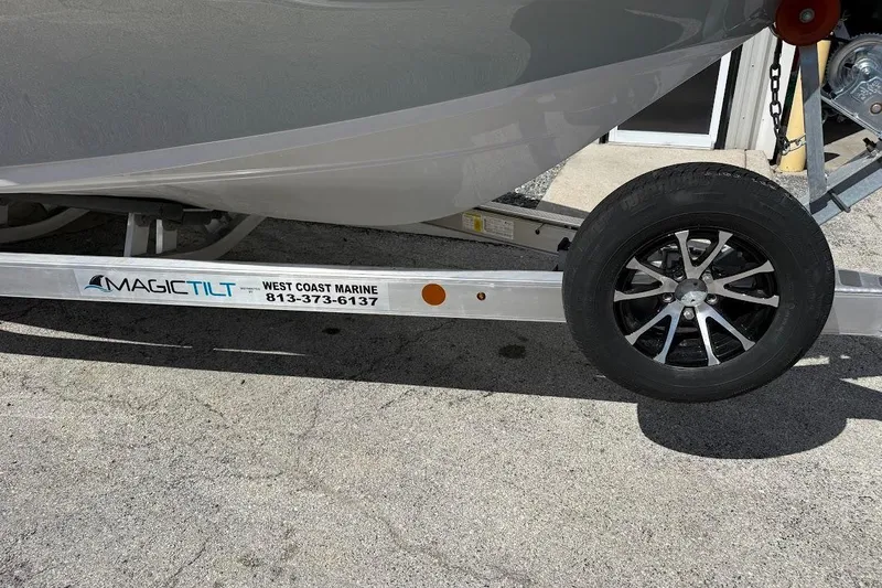 Slide: The Image of Trailer for 2026 Sea Pro 230 Bay boat with Magic Tilt branding. - 2