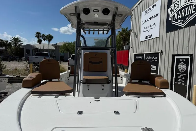 Slide: The Image of 2026 Sea Pro 230 Bay boat with tan seating, docked at West Coast Marine. - 3