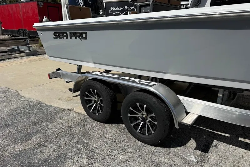 Slide: The Image of 2026 Sea Pro 230 Bay boat on trailer, featuring sleek design and modern wheels. - 4