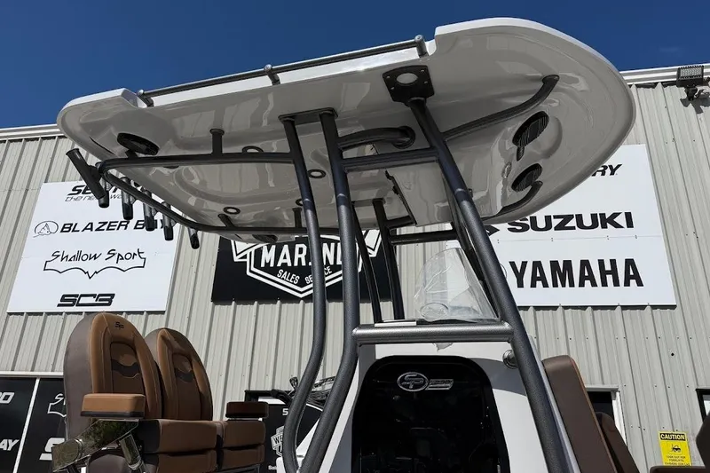 Slide: The Image of 2026 Sea Pro 230 Bay boat with T-top, displayed at a marine dealership. - 5