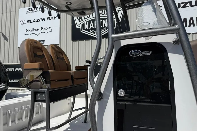 Slide: The Image of 2026 Sea Pro 230 Bay boat interior with brown seating and control panel. - 6