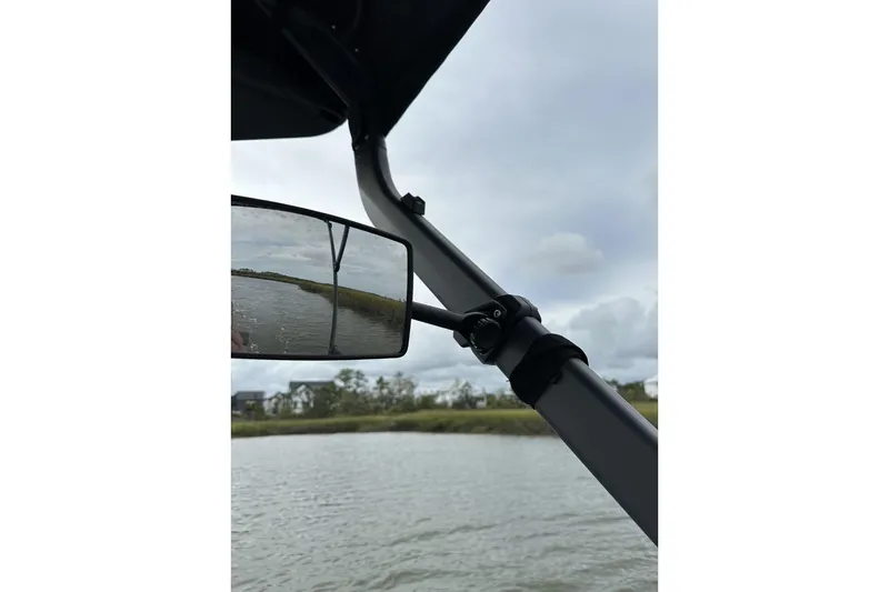 Slide: The Image of 2023 Bombardier Sea Doo mirror view on a calm waterway. - 11