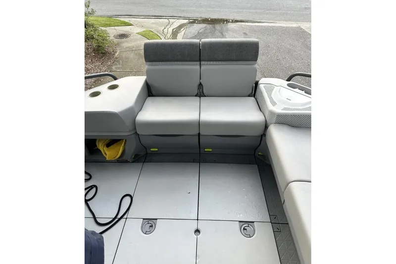 Slide: The Image of 2023 Bombardier Sea Doo interior seating with cup holders and storage compartments. - 15