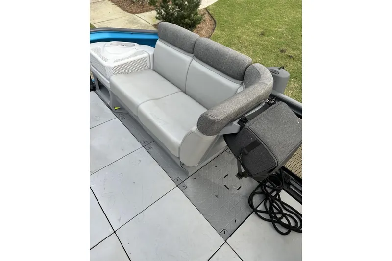 Slide: The Image of 2023 Bombardier Sea Doo interior with gray seating and storage compartment. - 16