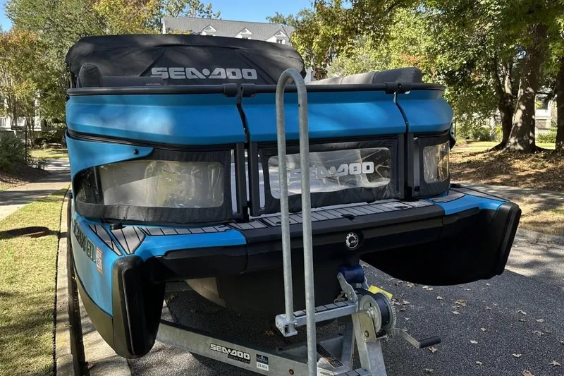 Slide: The Image of 2023 Bombardier Sea Doo on trailer, parked outdoors, showcasing sleek blue design. - 2