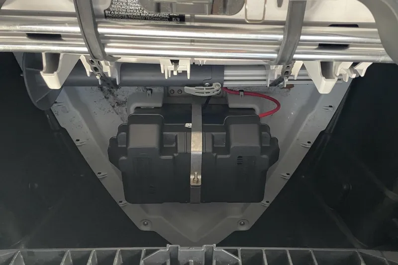 Slide: The Image of 2023 Bombardier Sea Doo battery compartment with secured battery and wiring. - 22