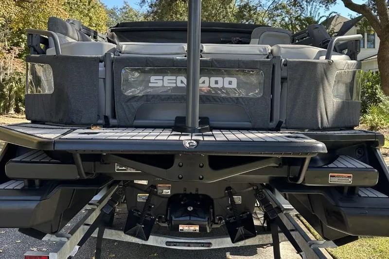 Slide: The Image of 2023 Bombardier Sea Doo rear view on trailer, showcasing seating and deck features. - 6