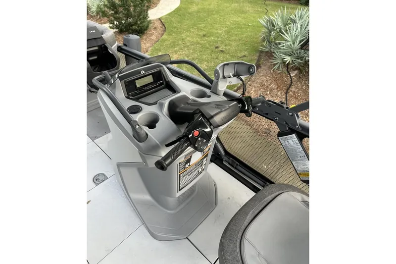 Slide: The Image of 2023 Bombardier Sea Doo dashboard with controls and display, parked on grass. - 7