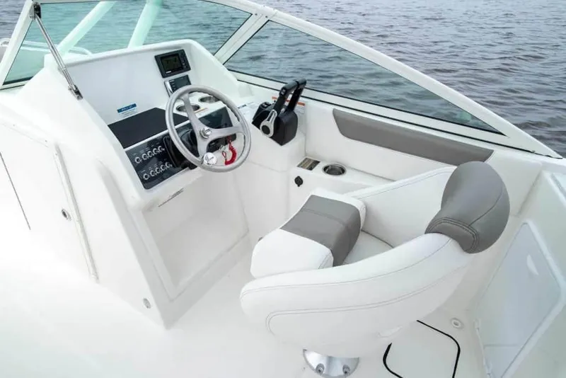 Slide: The Image of Manufacturer Provided Image: 2026 World Cat 230 SD boat cockpit with steering wheel and comfortable seating. - 12