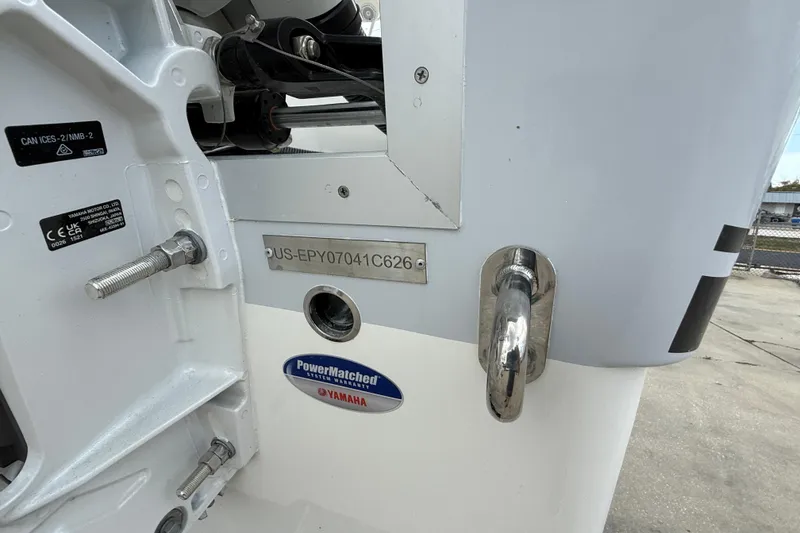 Slide: The Image of Close-up of a 2026 World Cat 230 SD boat's identification plate and Yamaha warranty sticker. - 24