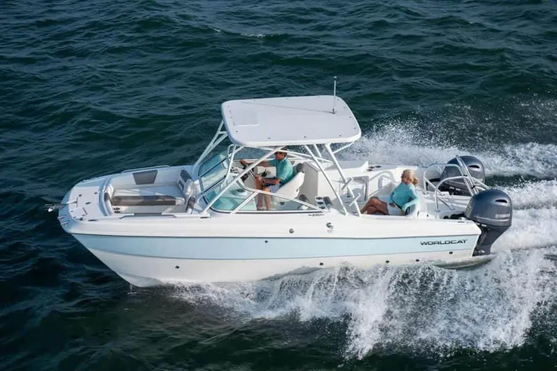 Slide: The Image of 2026 World Cat 230 SD boat on trailer, parked outdoors under cloudy sky. - 4