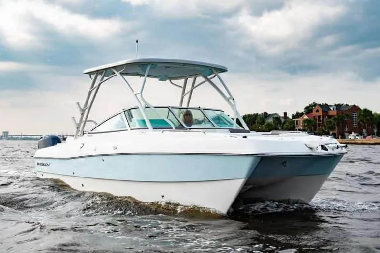 The Image of Manufacturer Provided Image: 2026 World Cat 230 SD boat cruising on a cloudy day near the shoreline. - 5