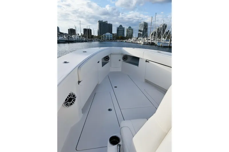 Slide: The Image of 2020 SeaVee 370Z boat interior with sleek white design, docked in a marina. - 10