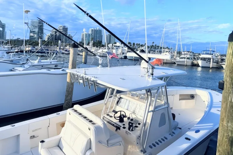 Slide: The Image of 2020 SeaVee 370Z boat docked at marina with city skyline in background. - 13