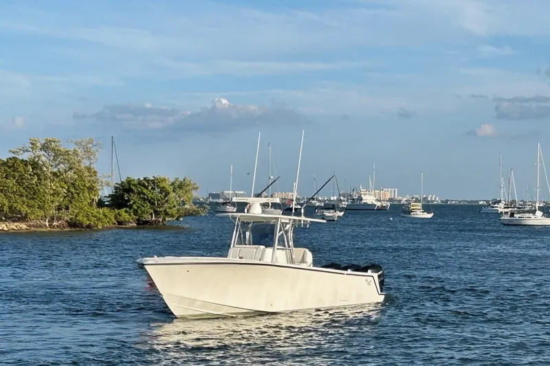 Slide: The Image of 2020 SeaVee 370Z boat cruising on a sunny day with other boats in the background. - 4
