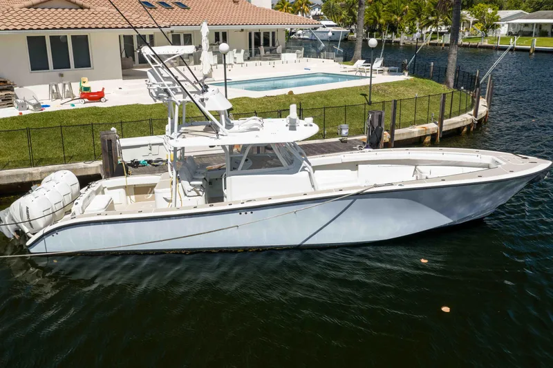The Image of 2011 Yellowfin 42 Offshore boat docked near waterfront home with pool. - 1