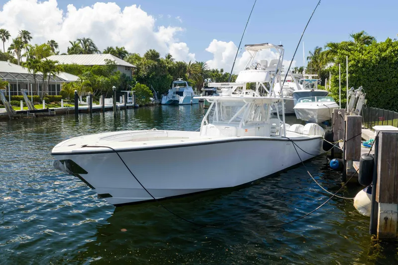 Slide: The Image of 2011 Yellowfin 42 Offshore boat docked in a scenic marina setting. - 2