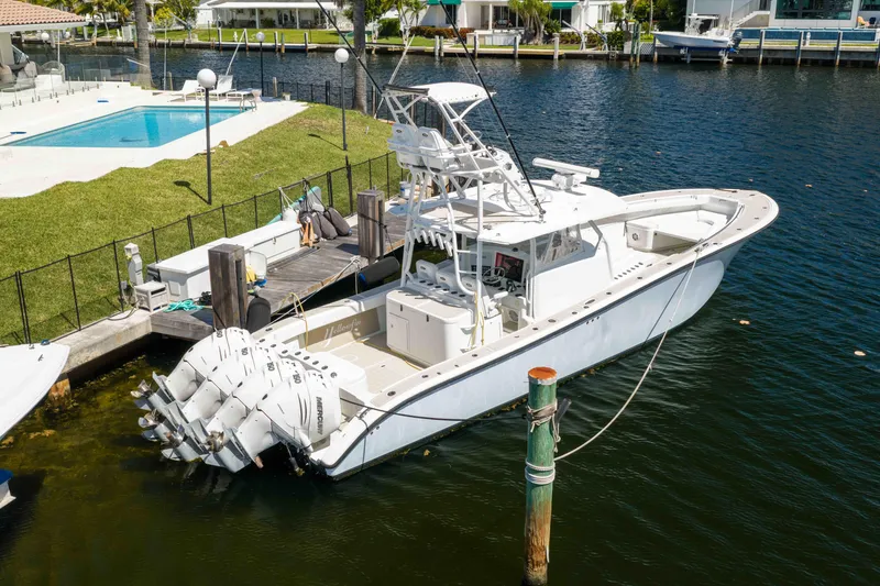 Slide: The Image of 2011 Yellowfin 42 Offshore boat docked by a waterfront property with pool. - 5