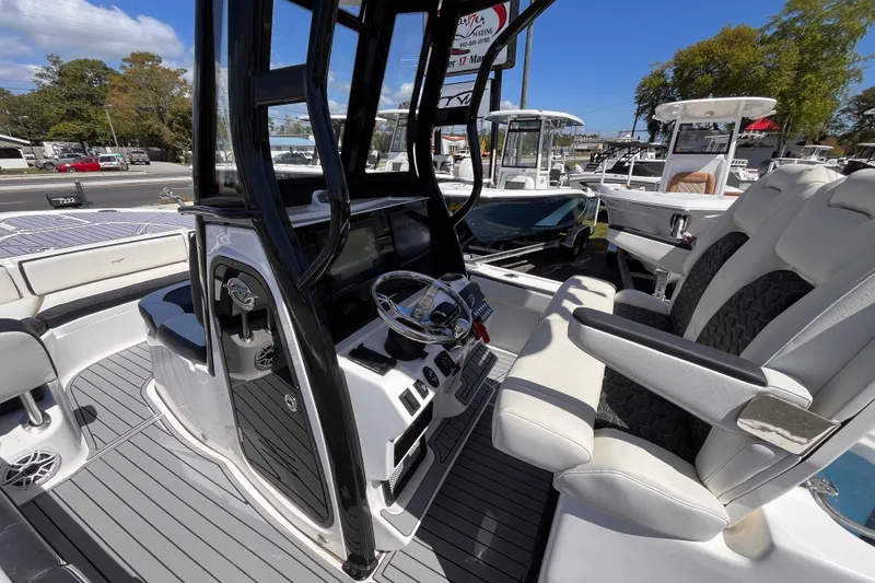 Slide: The Image of 2024 Tidewater 2700 Carolina Bay boat interior with modern helm and seating. - 15