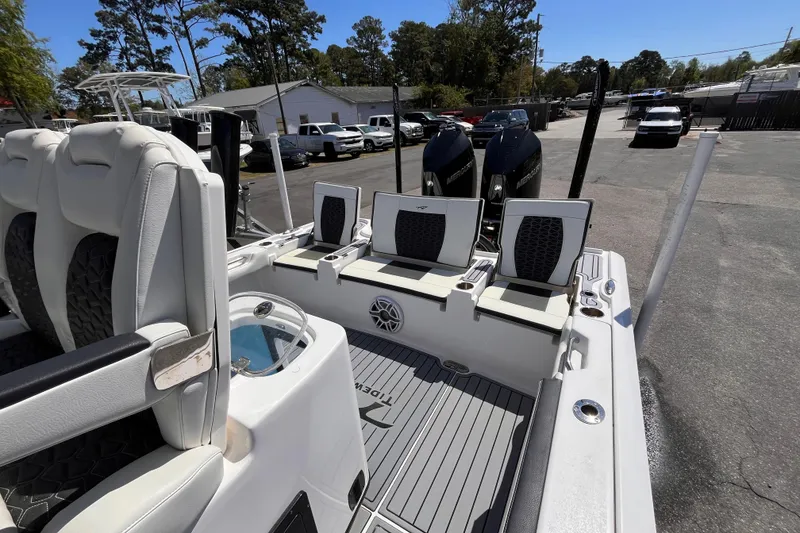 Slide: The Image of 2024 Tidewater 2700 Carolina Bay boat interior with seating and dual Mercury engines. - 17