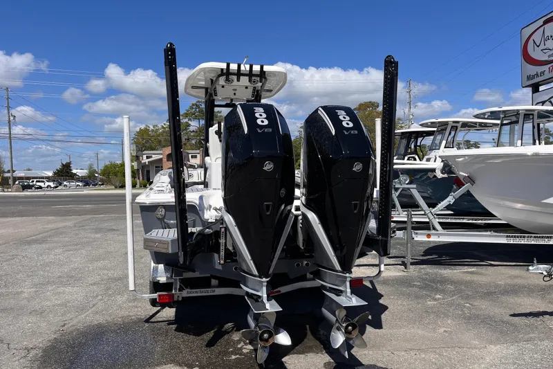 Slide: The Image of 2024 Tidewater 2700 Carolina Bay boat with dual 300 V8 engines, parked outdoors. - 3