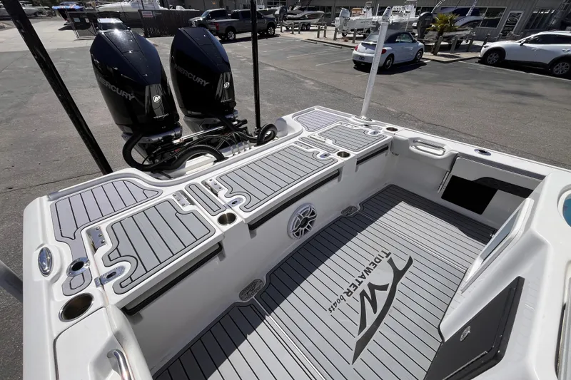 Slide: The Image of 2024 Tidewater 2700 Carolina Bay boat with dual Mercury engines, docked in a marina. - 5