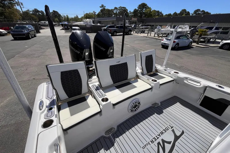 Slide: The Image of 2024 Tidewater 2700 Carolina Bay boat with dual Mercury engines, docked in a marina. - 6
