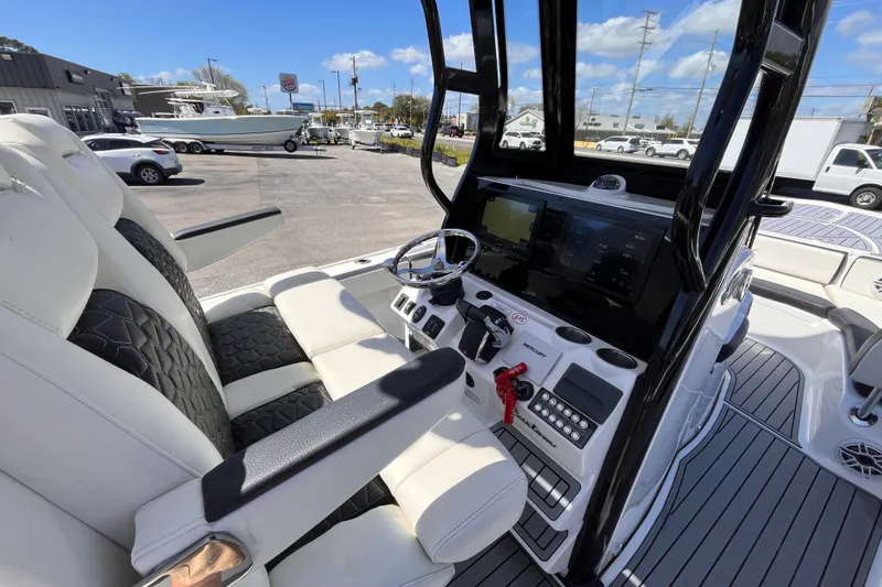 Slide: The Image of 2024 Tidewater 2700 Carolina Bay boat interior with modern helm and seating. - 9