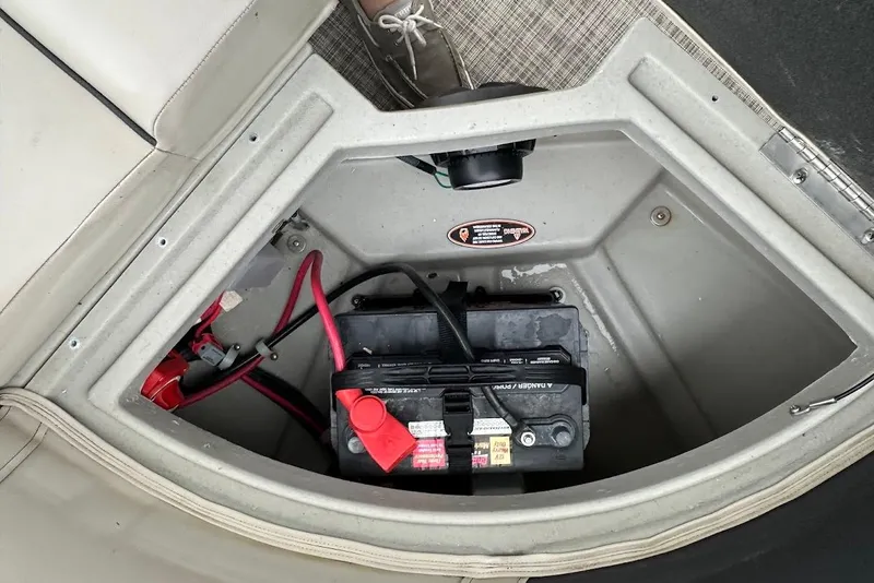 Slide: The Image of Battery compartment of 2023 Harris Cruiser 230 boat with visible wiring. - 32