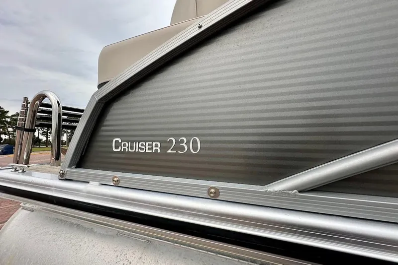 Slide: The Image of 2023 Harris Cruiser 230 pontoon boat, close-up view of side panel and railing. - 8