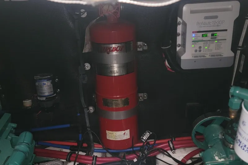 Slide: The Image of Engine compartment of 2006 Wellcraft 330 Coastal with fire extinguisher and electrical panel. - 23