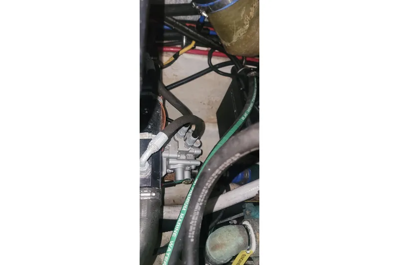 Slide: The Image of Engine compartment of a 2006 Wellcraft 330 Coastal boat, showing hoses and wiring. - 28