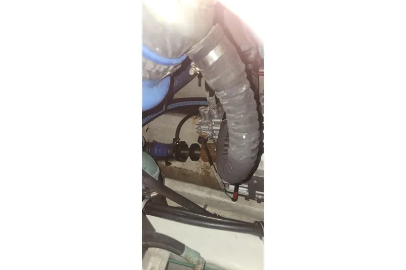Slide: The Image of Engine compartment of a 2006 Wellcraft 330 Coastal boat, showing hoses and components. - 29