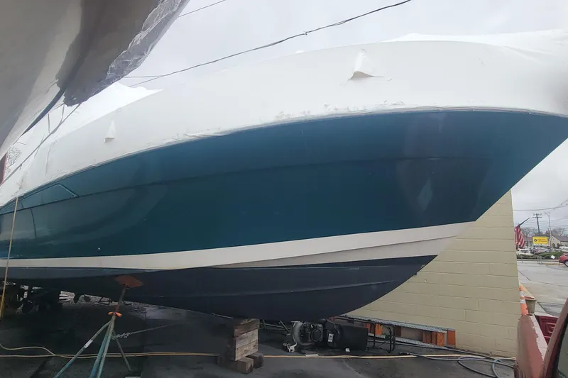 Slide: The Image of 2006 Wellcraft 330 Coastal boat in dry dock, covered and elevated for maintenance. - 3