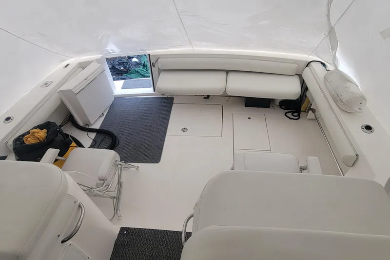 Slide: The Image of 2006 Wellcraft 330 Coastal boat interior with white seating and storage compartments. - 7