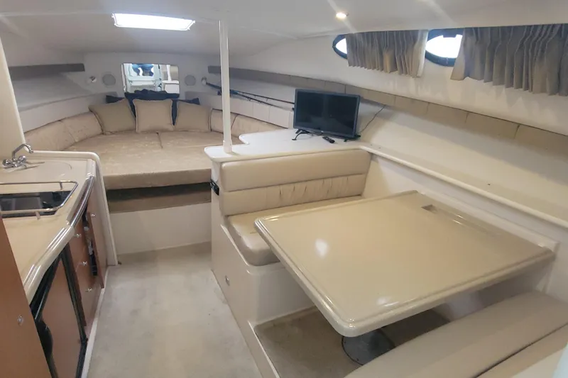 Slide: The Image of Interior of 2006 Wellcraft 330 Coastal boat with seating, table, and bed. - 9