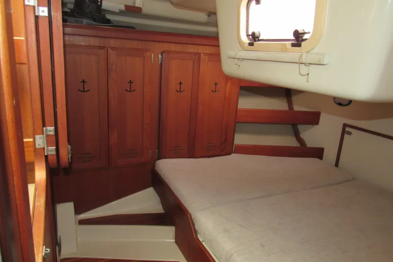 Slide: The Image of Interior cabin of 1991 Marlow-Hunter 37.5 sailboat with wooden cabinetry and cozy bed. - 13