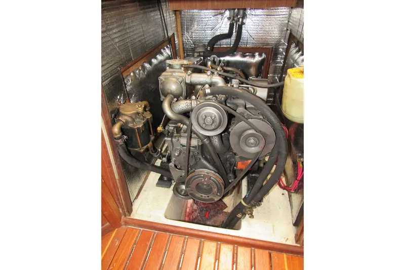 Slide: The Image of Engine compartment of a 1991 Marlow-Hunter 37.5 sailboat, showcasing mechanical components. - 16