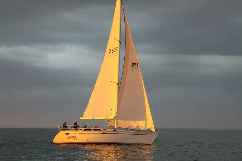 Slide: The Image of Sailing yacht Hunter Legend 37.5, 1991 model, gliding on calm waters at sunset. - 3