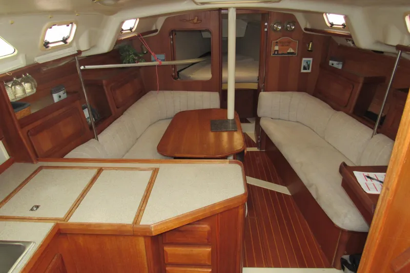 Slide: The Image of Interior of 1991 Marlow-Hunter 37.5 sailboat with cozy seating and wooden finishes. - 5