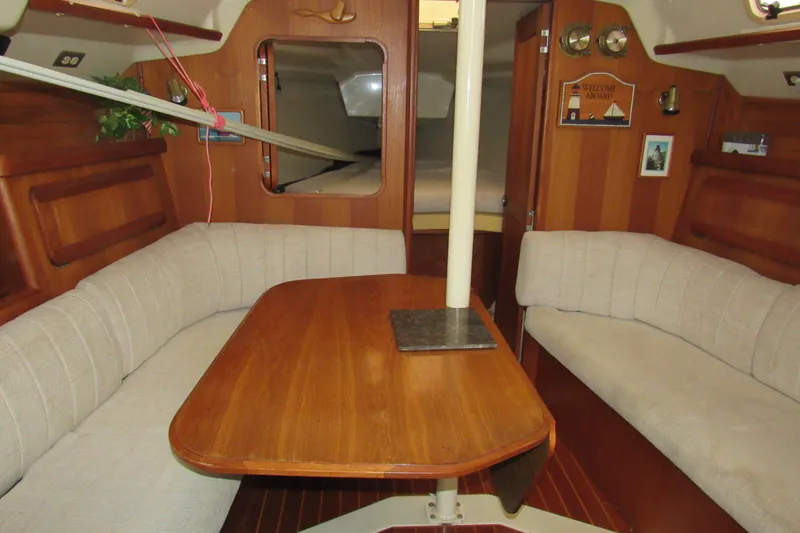 Slide: The Image of Interior of 1991 Marlow-Hunter 37.5 sailboat with wooden table and cushioned seating. - 6