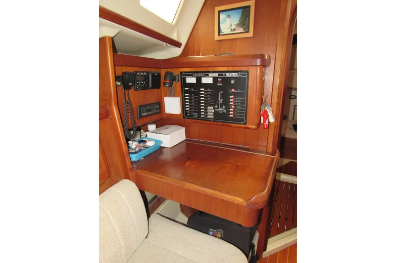 Slide: The Image of Navigation station inside 1991 Marlow-Hunter 37.5 sailboat with control panel and communication equipment. - 9