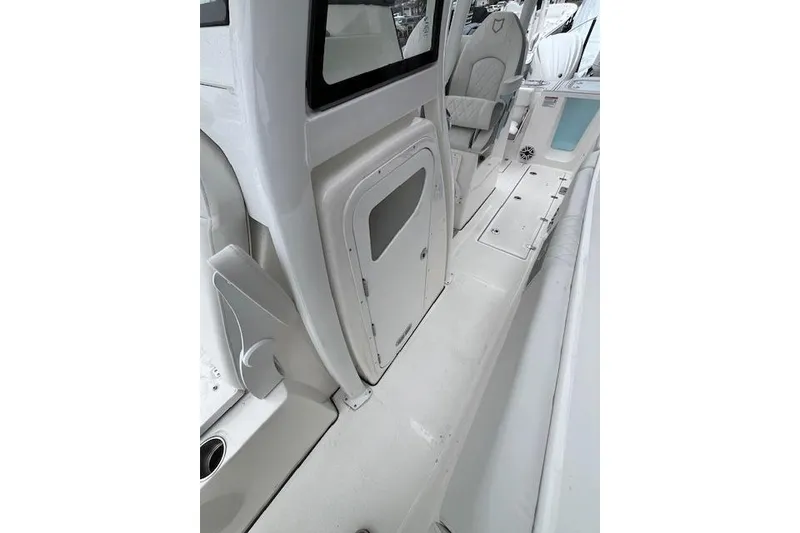 Slide: The Image of 2026 Sea Fox 288 Commander boat interior, featuring sleek white design and seating area. - 11