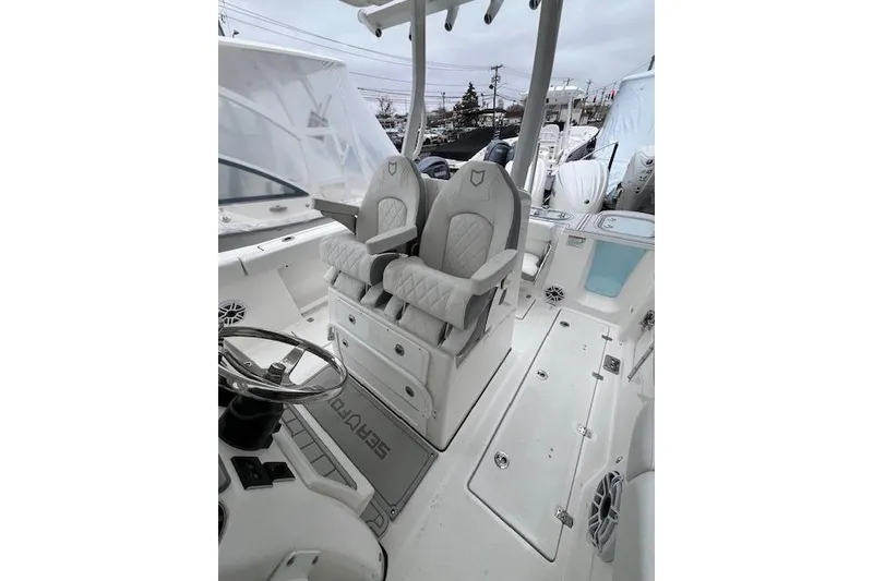 Slide: The Image of 2026 Sea Fox 288 Commander boat interior with dual captain's chairs and steering wheel. - 13