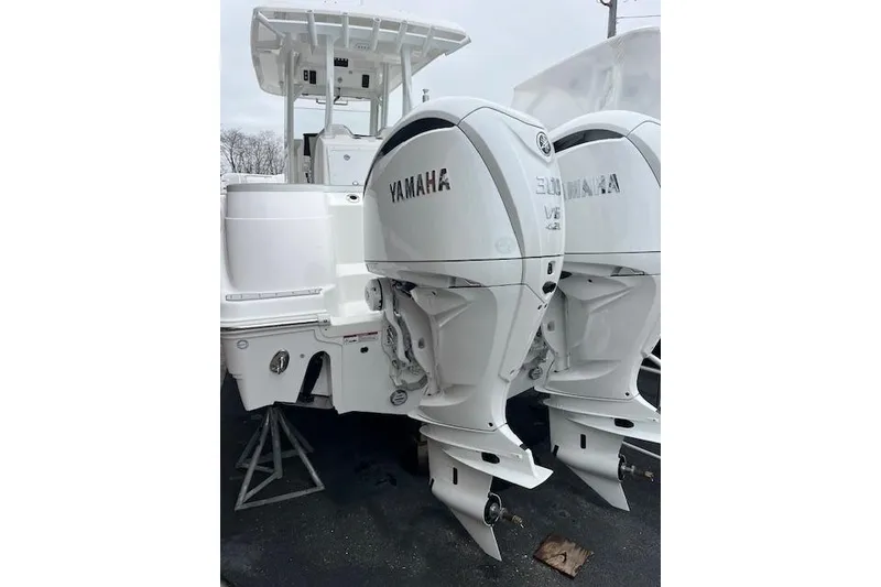 Slide: The Image of 2026 Sea Fox 288 Commander with dual Yamaha outboard engines, parked on a stand. - 2