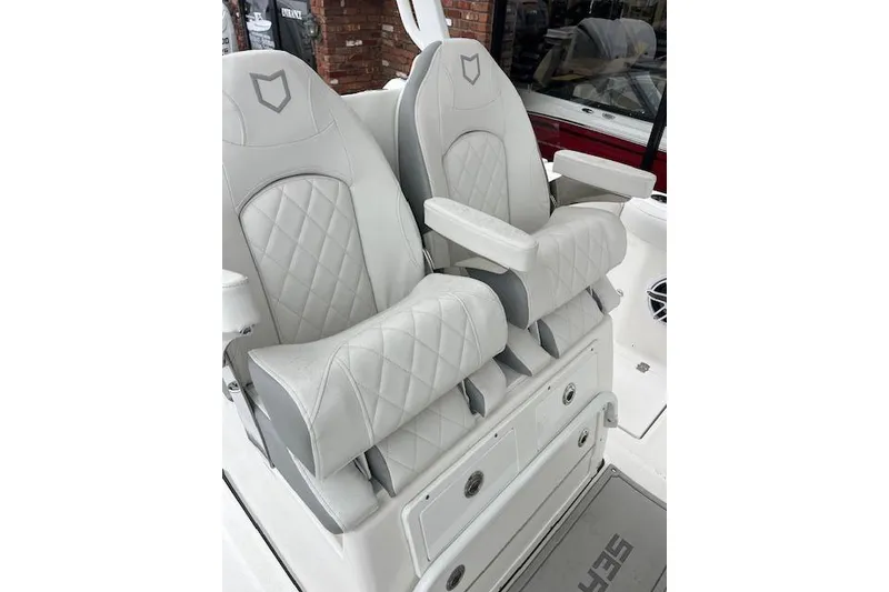 Slide: The Image of Luxury seating on 2026 Sea Fox 288 Commander boat, featuring quilted upholstery and armrests. - 7