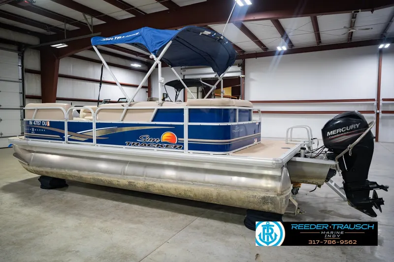 Slide: The Image of 2014 Sun Tracker Party Barge 20 DLX pontoon boat with Mercury outboard motor in indoor storage. - 10